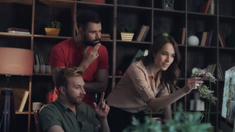 Business-team-discussing-new-project-on-computer-screen-in-cozy-office