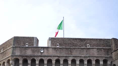 italian flag flying high over the castel sant'angelo in rome