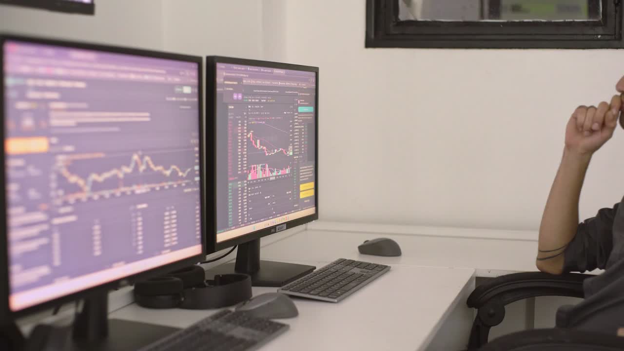Stock market volatility creating intense tension for professional trader analyzing crashing financial data on multiple computer screens