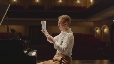 pianist throwing away sheet music and playing grand piano