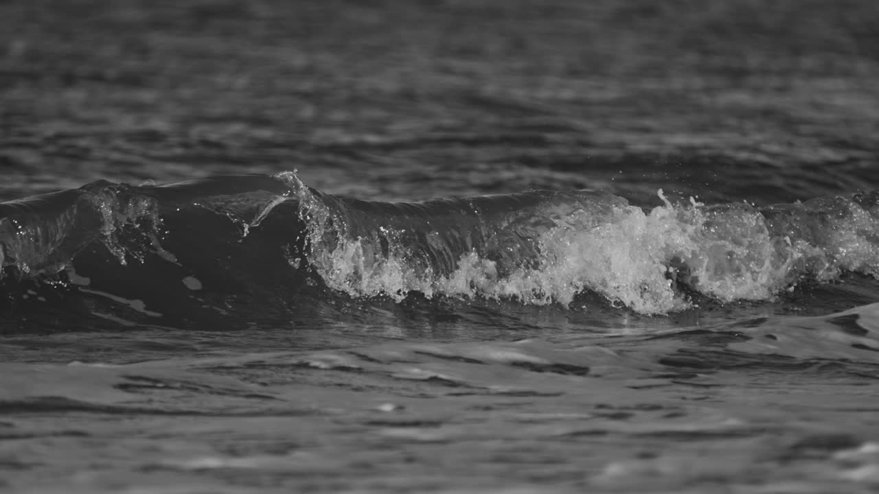 Gentle ocean wave rolling in super slow motion, peaceful and calm water scene