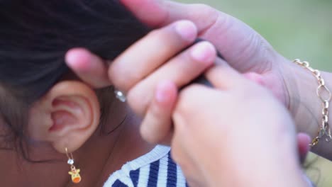 Close-up-shot-of-woman-hand-stroking-hair-black-hair