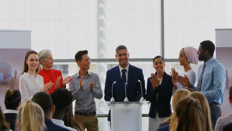 businessman standing on the podium with his colleagues in the business seminar 4k