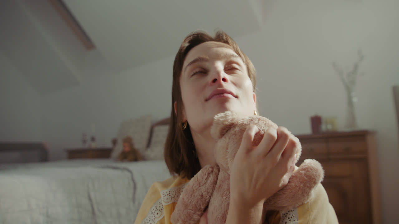 A girl playing with dolls in her room