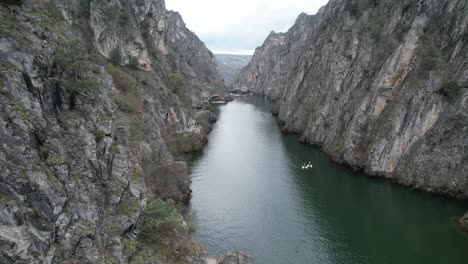 View-of-beautiful-tourist-attractions,-the-lake-at-Matka-Canyon-in-the-Skopje-surroundings,-people-canoeing-on-the-lake,-Macedonia