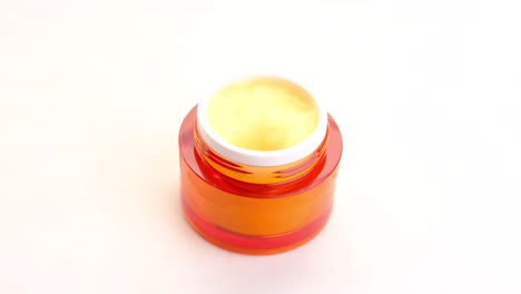 orange cosmetic cream jar