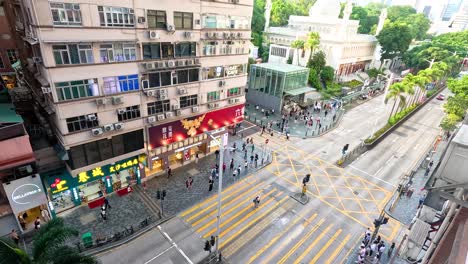 pedestrians and vehicles at a bustling city intersection