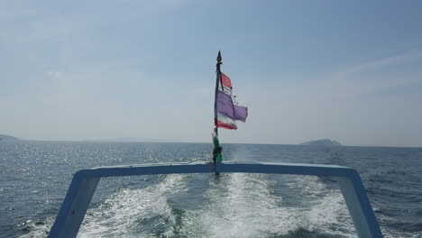 a view of the thailand flag waving on the boat's tail