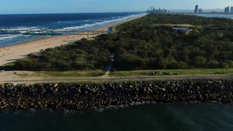 gold coast seawall view of surfers paradise. sunset,drone flying sideways