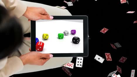 Tablet-showing-dices-with-Pokercards-background-Video-
