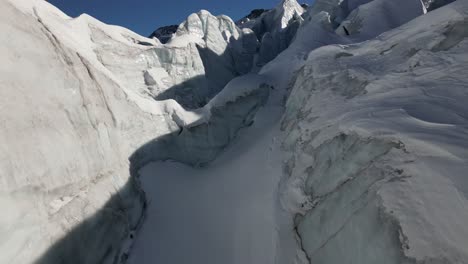 Icy-peaks-in-a-Swiss-alps-glacier,-aerial-push-in,-snow-covered-ice