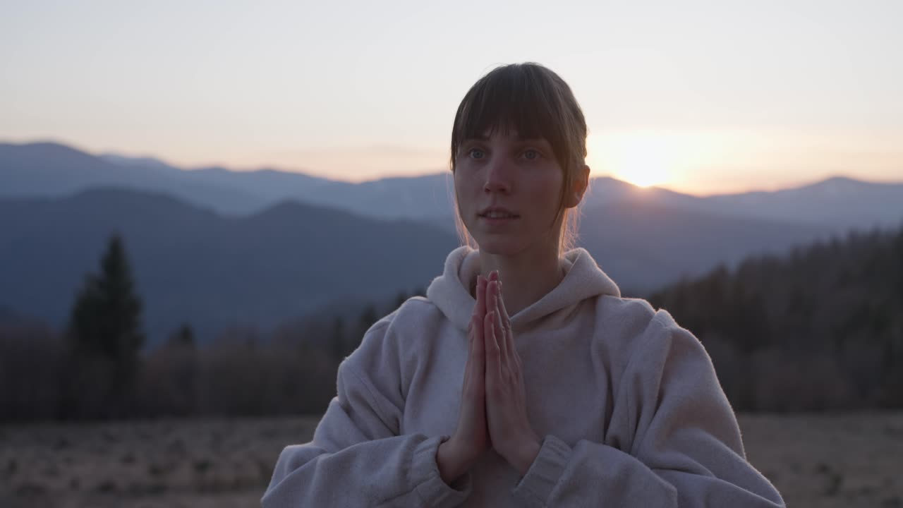 Woman meditating in nature at dawn