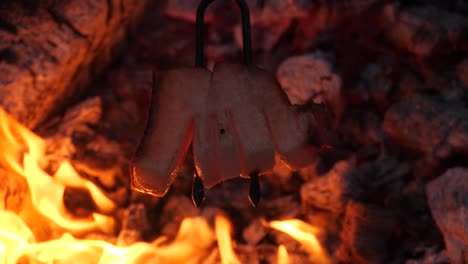 bacon on a fork skewer at a barbecue - 180 fps slow motion