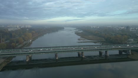 aerial view of the morning warsaw with the gdanski bridge in the foreground and the dominant coal-fired power plant in the background camera descending and approaching the bridge