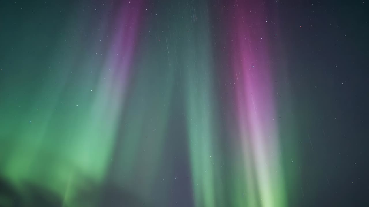 Pulsing aurora shifting over night sky, solar wind driving stars and horizon silhouette