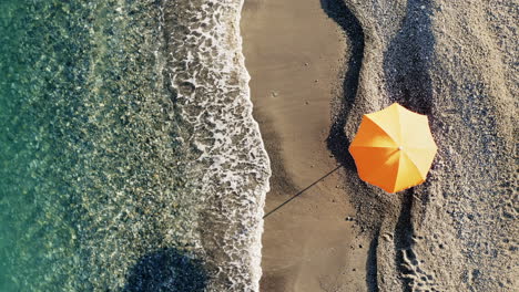 orange umbrella on a sandy beach