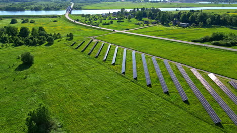 solar panel farm in the green countryside provides clean energy - drone parallax