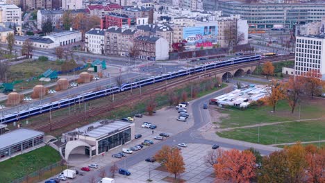 warsaw, poland. tracking shot of train leaving national stadium railway station in autumn season