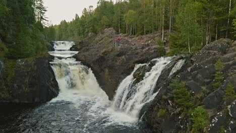 Aerial-footage-of-a-Karelian-waterfall-Kivach,-full-water-stream-main-view,-beautiful-nature,-foam-on-water