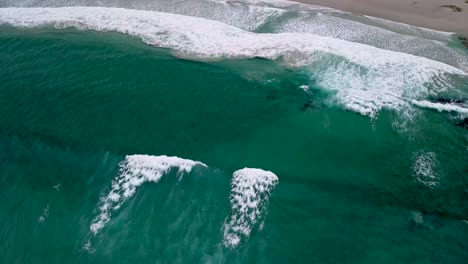 foto aérea de la playa de caion grandes olas arrastrándose suavemente a la orilla durante el día en a coruña, españa