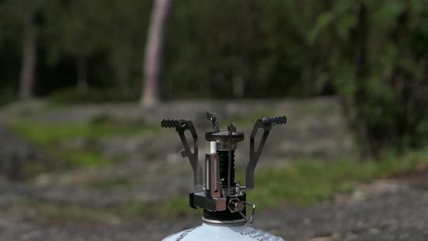 turning on outdoor camping gas stove, putting moka pot on gas stove taking it off