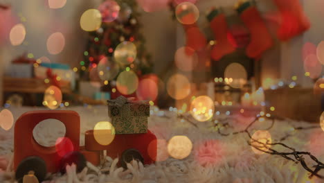 animación de navidad parpadeando luces de hadas sobre juguete de madera en la sala de estar