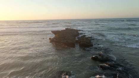 Hermosa-Puesta-De-Sol-Dramática-Sobre-El-Mar-O-El-Océano-En-La-Playa-Con-Un-Cielo-Dramático-Y-Rocas-Entrando-Al-Agua-En-La-Costa-Portuguesa