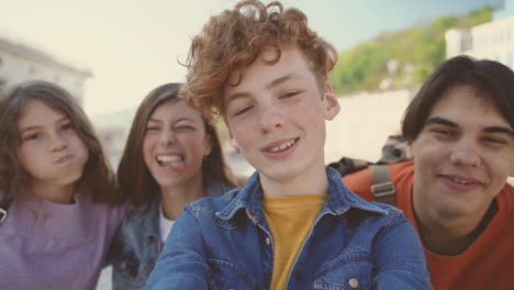 a group of teenagers with two girls and two boys take a funny selfie 3