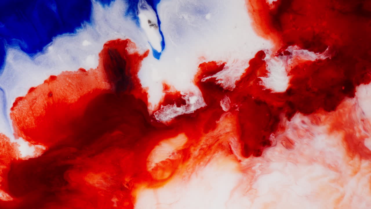 Red, White, And Blue Ink Colors Flowing And Blending On The Surface