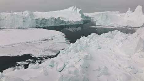 drone over sea and ice of ilulissat icefjord