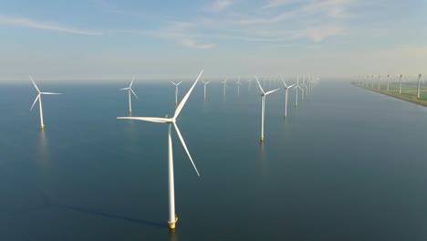 huge windmill turbines, offshore windmill farm in the ocean westermeerwind park , windmills isolated at sea on a beautiful bright day netherlands flevoland noordoostpolder