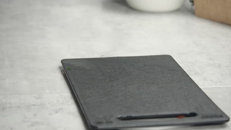 Narrow-focus-close-up:-Knife-is-placed-on-small-kitchen-cutting-board