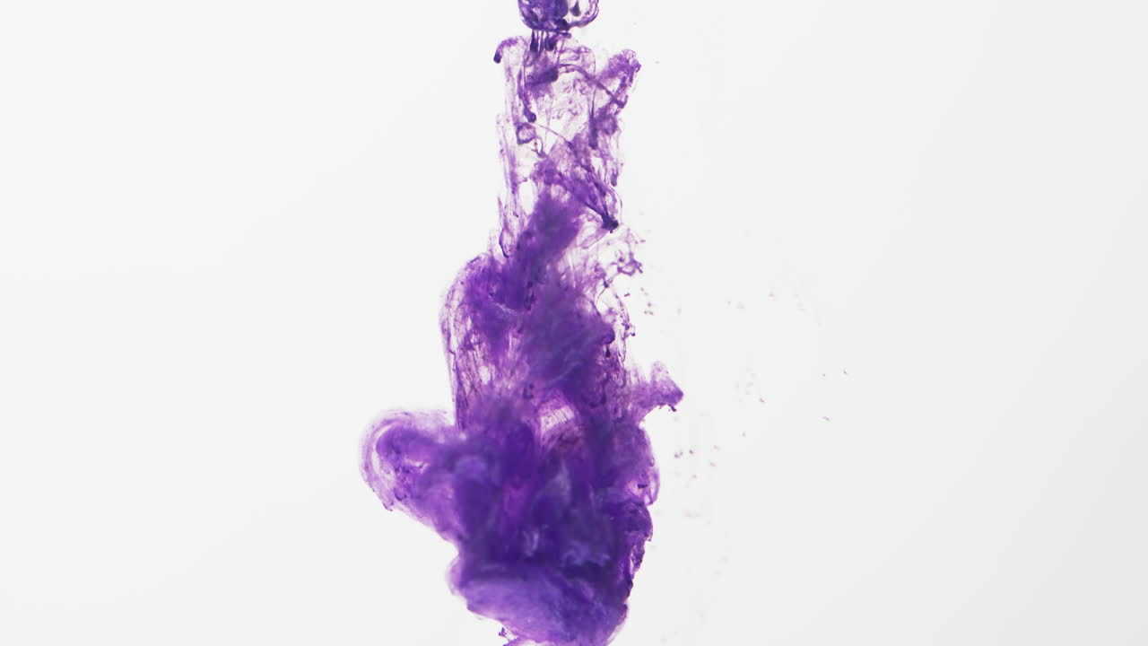 Slow motion video of purple watercolor ink mixing in water against grey background