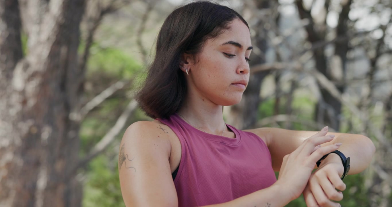 Young Woman Checking Her Smartwatch After Outdoor Exercise