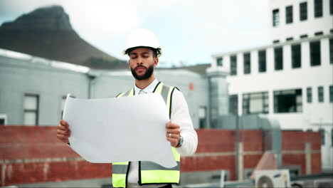 construction worker with blueprint on site