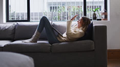 woman having a video chat on her laptop at home