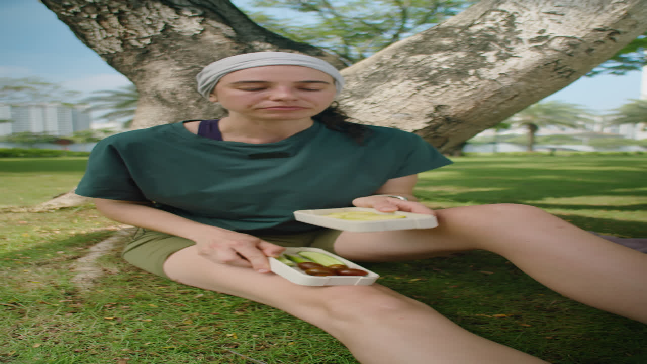 Sportive Girl Eating Vegan Snack after Outdoor Workout