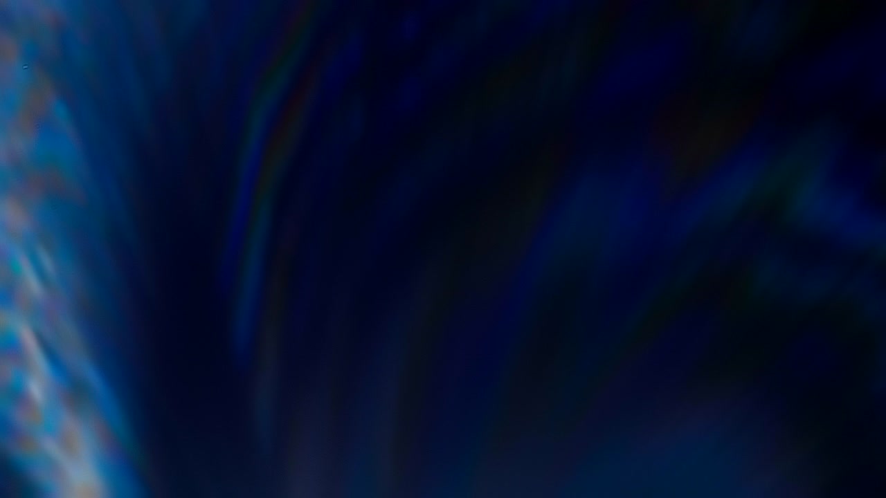 Colorful flares in lens from a bright light source on a black background