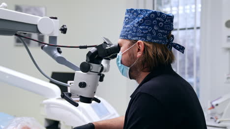 dentist using microscope during procedure