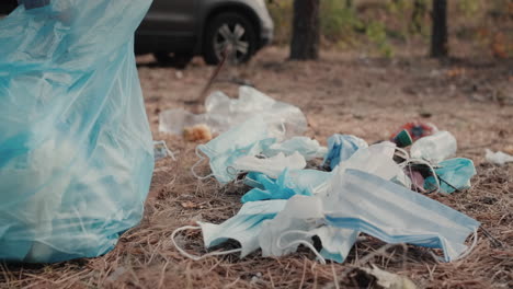 volunteer picks up garbage in a forest 1