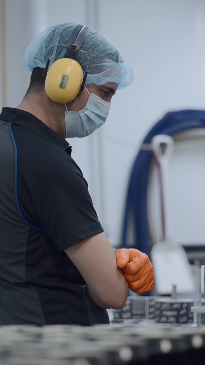 Worker in a manufacturing facility wearing personal protective equipment