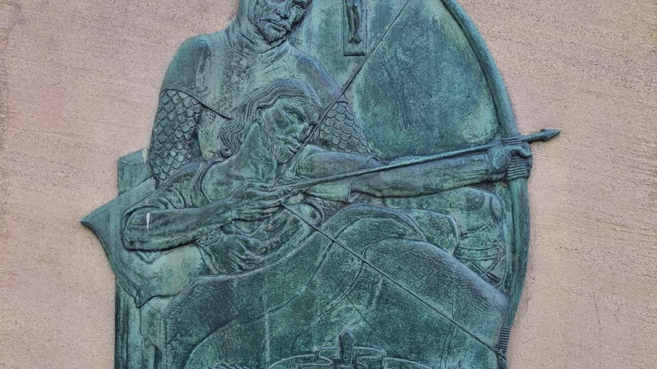 Plaque on a castle wall in Nottingham, UK, depicting Robin Hood with his drawn bow, honoring the legendary hero and rebel of Nottingham’s history