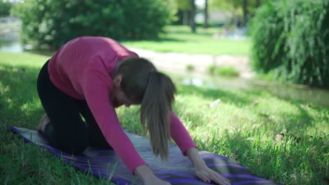 Woman-doing-Extended-child-and-cobra-asanas-in-park