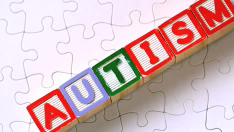 autism letter blocks falling onto jigsaw surface