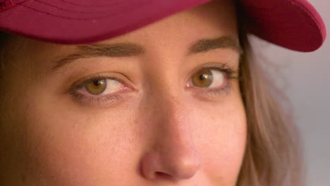 Close-up-portrait-of-a-gorgeous,-young-woman-wearing-a-red-hat-while-watching-the-sunset