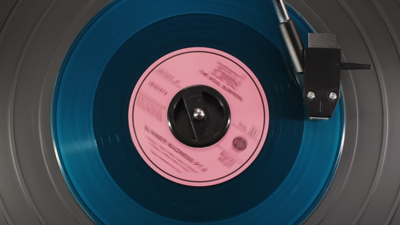 Retro Vinyl record player playing music, close-up macro shot of vintage LP disc old phonograph spinning. Retro music player.