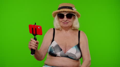 Senior-pensioner-woman-tourist-taking-selfie-portrait-photo,-making-video-call-on-mobile-phone