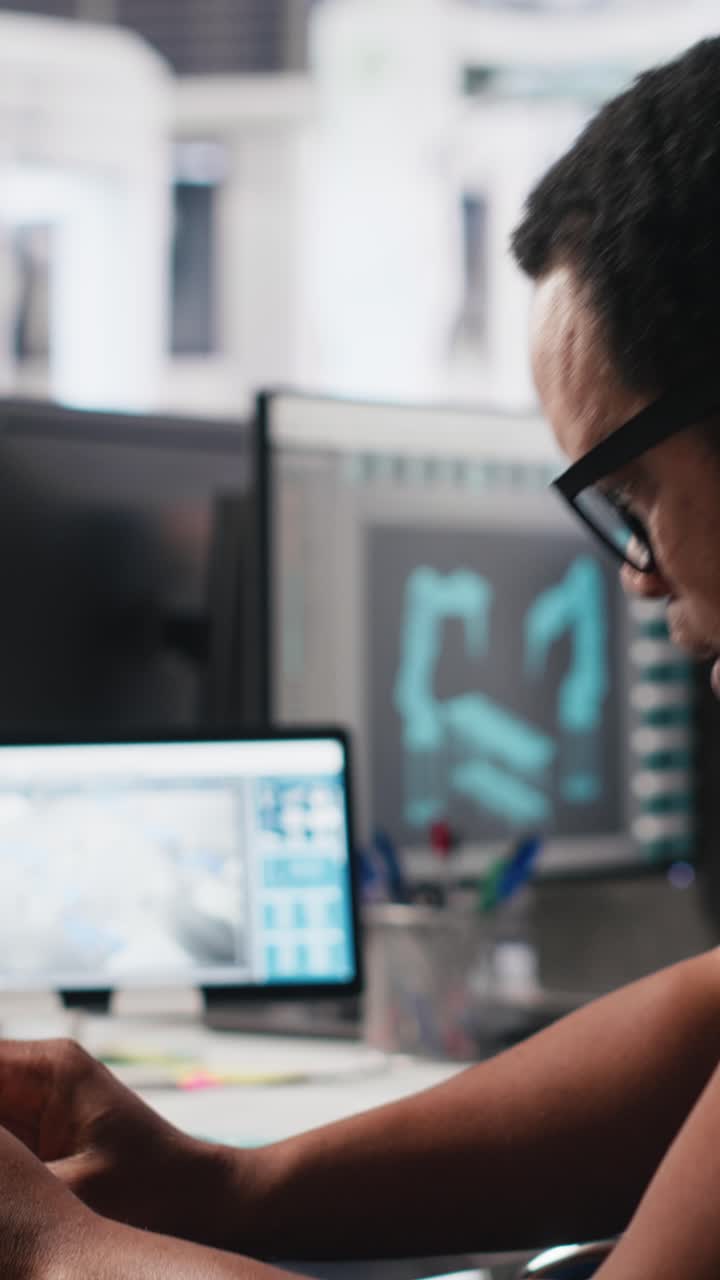 Vertical Video Black engineer with disability works on manufacturing solar panels