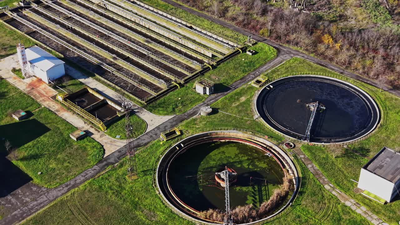 Aerial view of a water treatment facility with large circular tanks