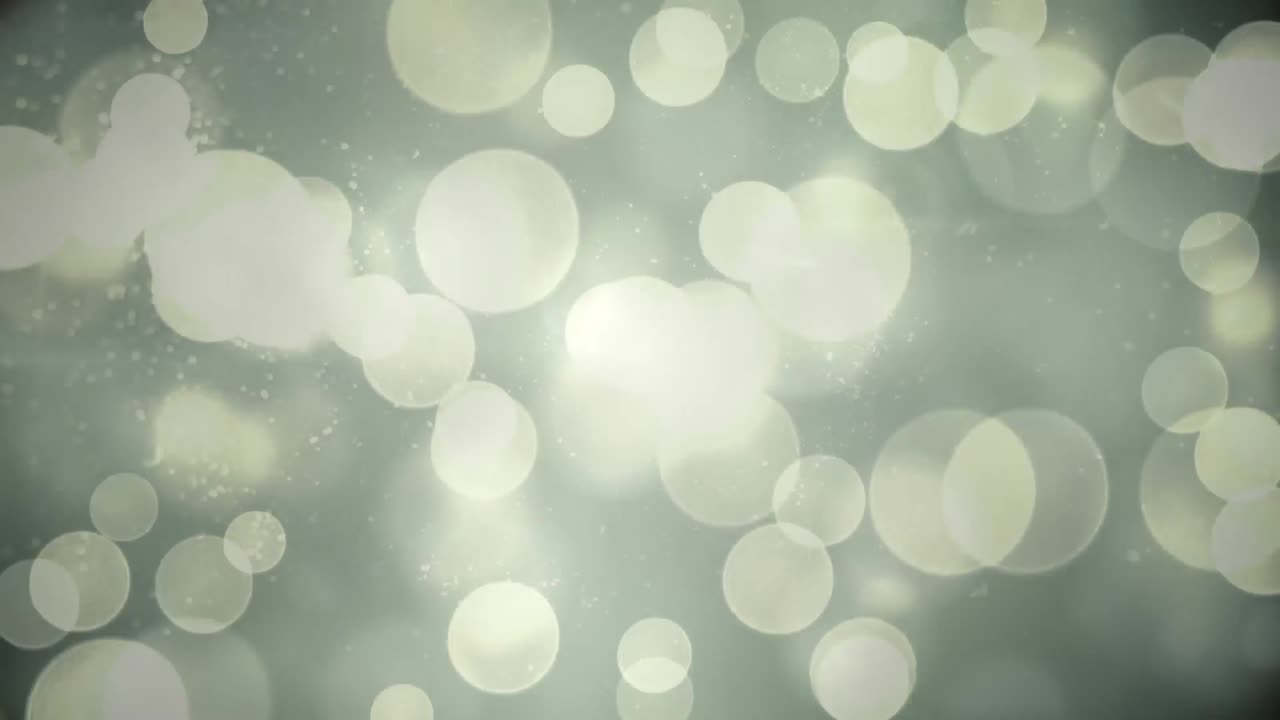 Animation of glowing bokeh christmas lights flashing over smoke on night sky
